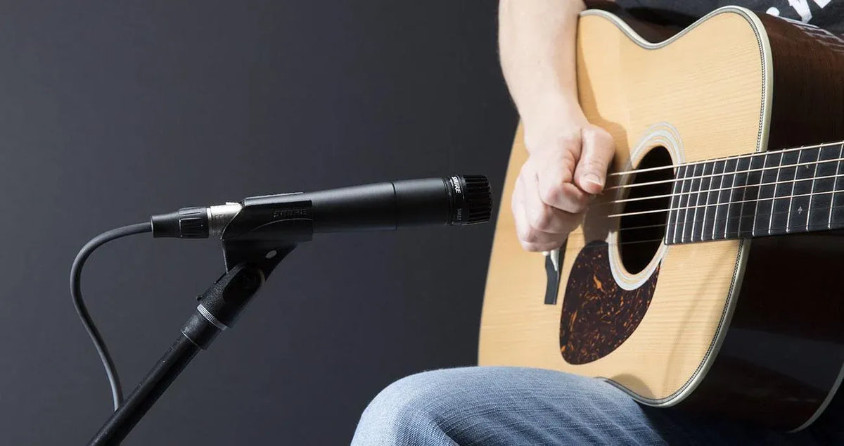 Shure SM57 microphone positioned for acoustic guitar recording