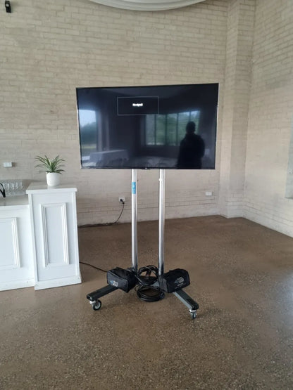 TCL 165cm (65”) 4K Mini-LED QLED TV on mobile stand at event venue