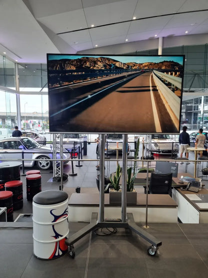 TCL 165cm (65”) 4K Mini-LED QLED TV on mobile stand at event venue