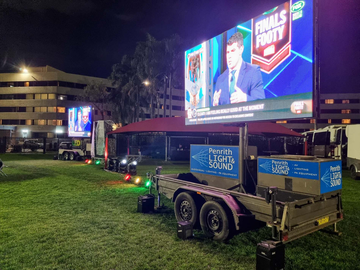 LED screen and lighting rig at a night event
